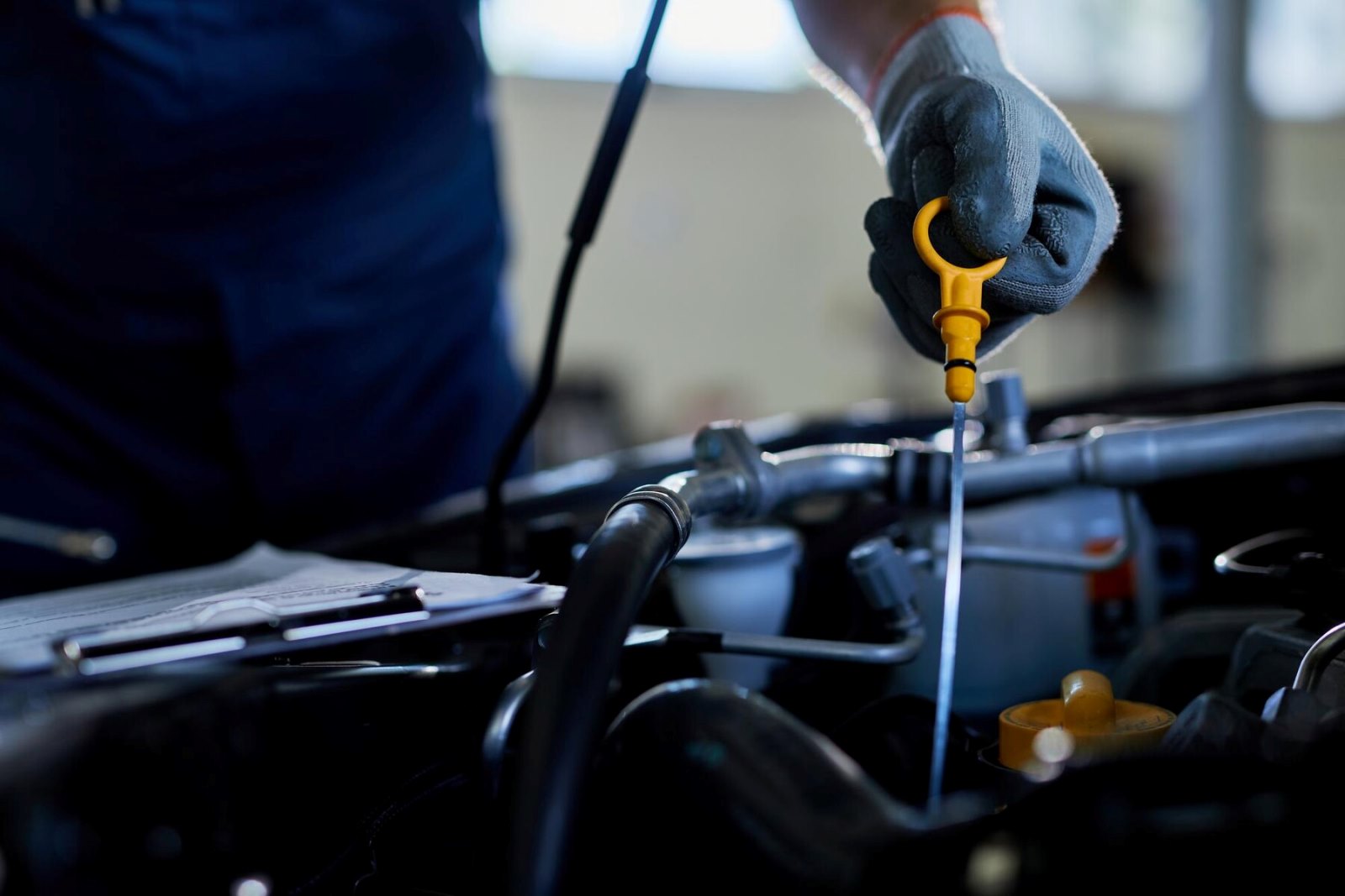 closeup-auto-repairman-checking-car-oil-workshop_637285-7638.jpg